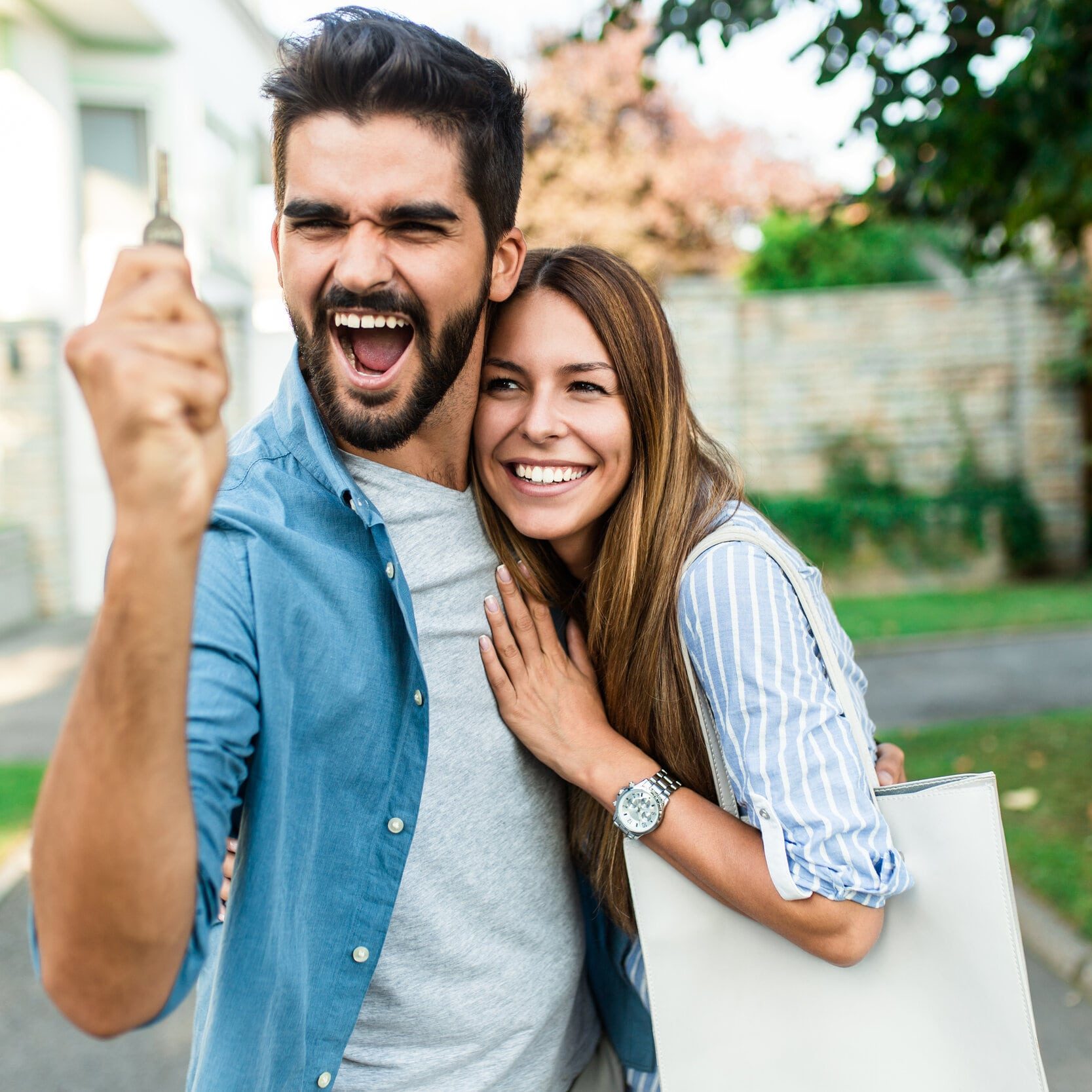 Happy couple celebrating after a successful property settlement in Perth, Western Australia.